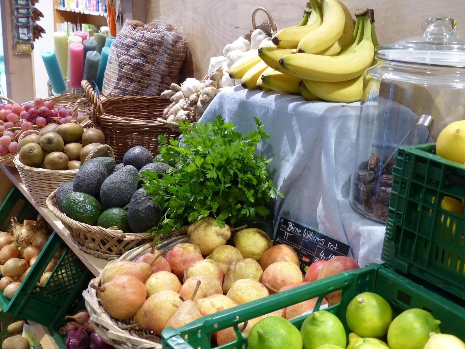 Obst und Gemüse in Körben: Birnen, Avocados, Petersilie, Bananen